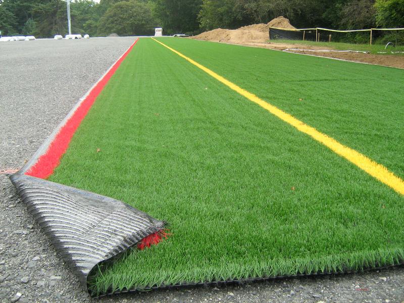 Artificial turf beside a running track