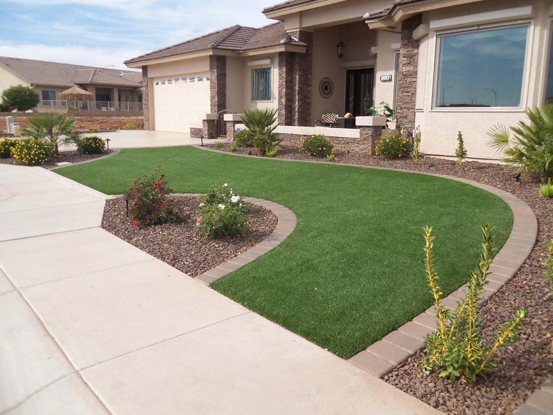 Artificial turf in a residential garden beside a path