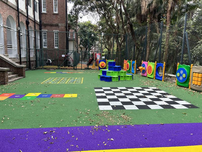 Colourful outdoor activity flooring with a checkerboard pattern