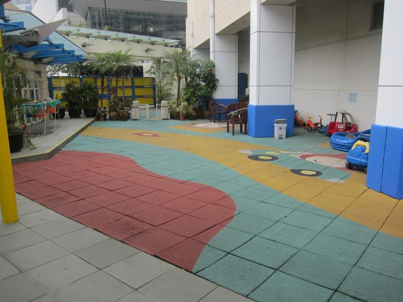 Colourful interlocking impact safety mats in an outdoor play area